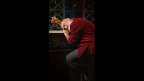 Drunk man in his 50s naps at bar counter after divorce, alcohol addiction Stock Footage 346714427