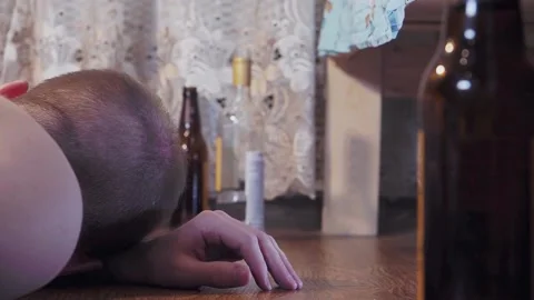 Drunk man lying on the floor by the bed Stock Footage 155493985