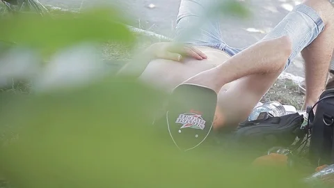 Drunk man lying on the grass. day. alcoholism. hangover Video stock 71943118