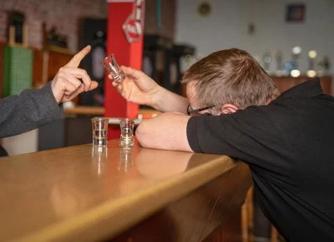 Drunk man no longer gets alcohol in the pub Stock Photos
