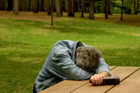 Drunk man in park Stock Photos