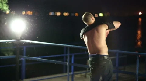 Drunk Man Puts a Shirt Stock Footage 47316919