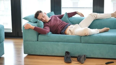 Drunk Man Resting on Couch at Home Stock Footage 100682741