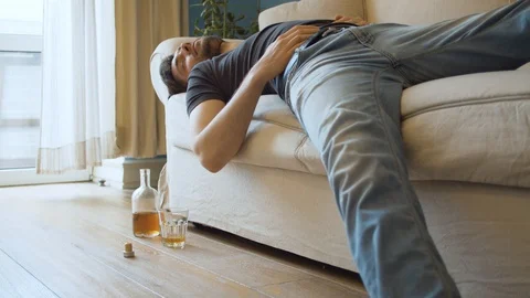 Drunk man sleeping on the couch Stock Footage 129282954