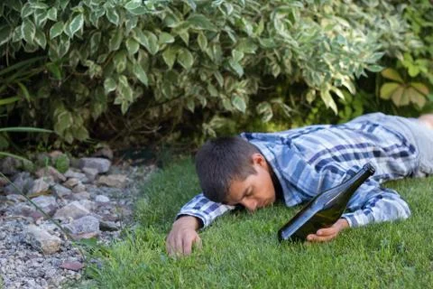 Drunk man sleeping in the park after the party. the problem of  alcoholism. Stock Photos