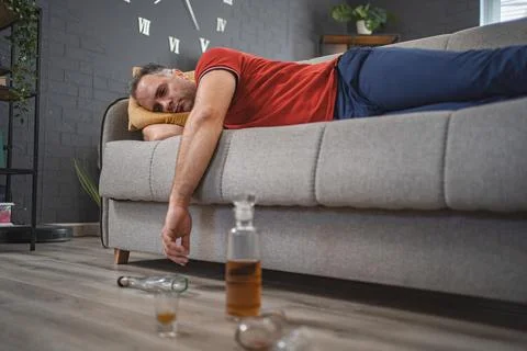Drunk man sleeping on a sofa Stock Photos