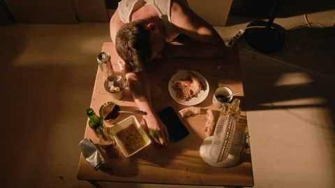 Drunk Man Sleeping on Table with Beer Bottles Showing Substance Abuse Stock Footage 344866708