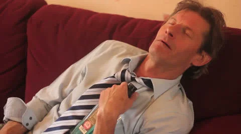 Drunk man on Sofa Stock Footage 25642170