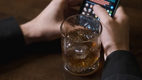 Drunk man writes message in phone, sends hearts,concept of alcoholic recreation Stock Footage 129802110