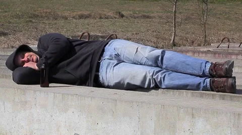 Drunk men sleeping near bottle of alcohol Vidéo 49429752