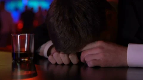 Drunk pub customer sleeping on bar counter, alcohol addict, depression problem Stock Footage 88839644