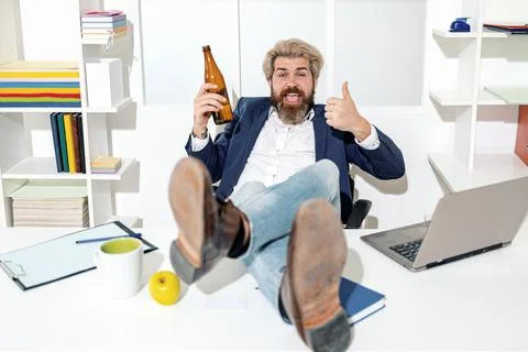 Drunk worker in office. Funny bearded drunk employee in the office. Happy office Stock Photos