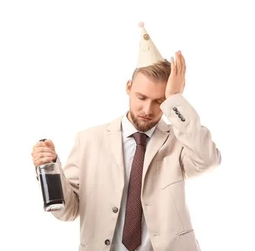 Drunk young man with bottle after party on white background Stock Photos