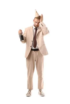 Drunk young man with bottle after party on white background Stock Photos