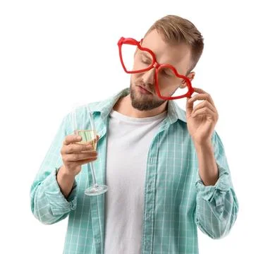 Drunk young man in eyeglasses with champagne after party on white background Stock Photos