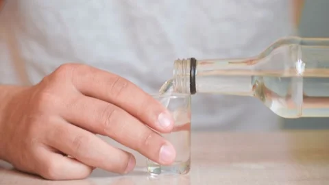 Drunkard guy bruised eye drinks alcoholic drink home. problem alcohol addiction Stock Footage 130962490