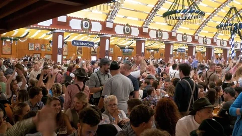 Drunken People inside large beer pub applauding and celebrate Oktoberfest Stock Footage 82176704