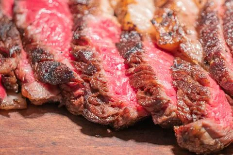 Dry-aged marble beef steak Tomahawk on wooden board with spices. Close-up, di Stock Photos