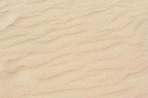 Dry beach sand with wave pattern as background Stock Photos