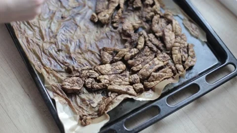 Dry beef lung on a baking sheet. Baked beef lung for dogs Video stock 240087360