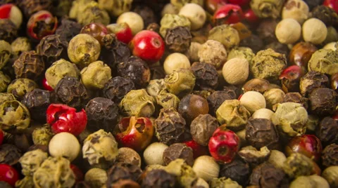 Dry black pepper, white pepper and red peppercorns close up rotation 4K Video stock 48014762