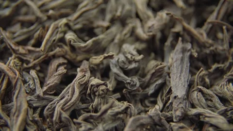 Dry black tea leaves rotate showing texture and curls Video stock 333834384