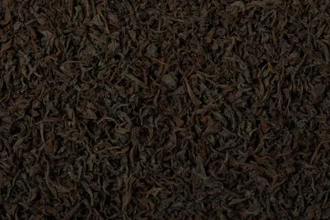 Dry black tea leaves texture background. Stock Photos