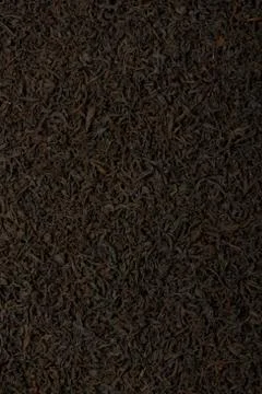 Dry black tea leaves texture background. Stock Photos