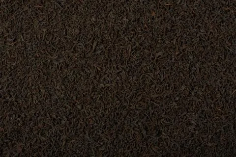 Dry black tea leaves texture background. Stock Photos