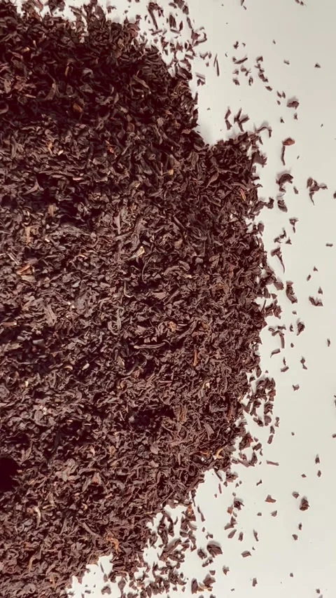 Dry black tea leaves on white background top view Stock Footage 336471316