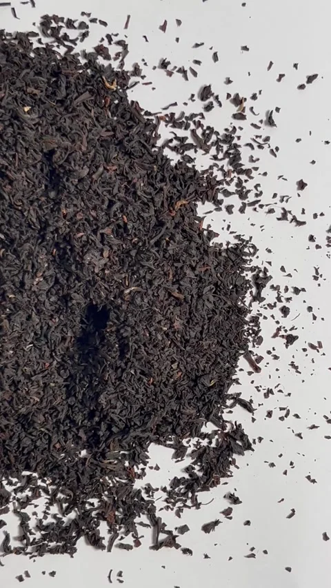 Dry black tea leaves on white background top view Stock Footage 336471319