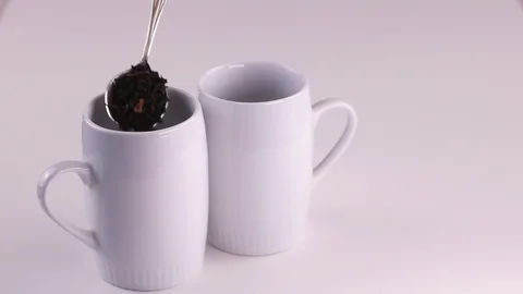 Dry black tea put in cups Stock Footage 120683340