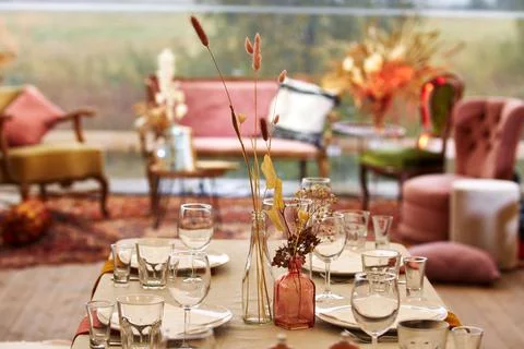 Dry bouquets on served table on empty light terrace in cafe Stock Photos