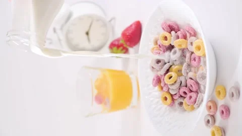 Dry breakfast in a bowl with milk. Multi-colored rings for children's breakfast Stock Footage 194007375