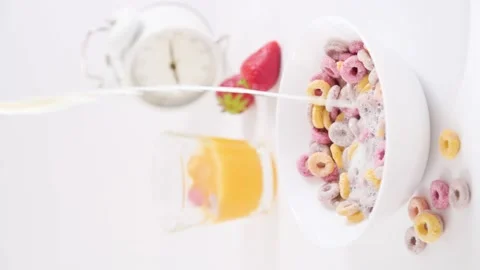 Dry breakfast in a bowl with milk. Multi-colored rings for children's breakfast Stock Footage 196120065