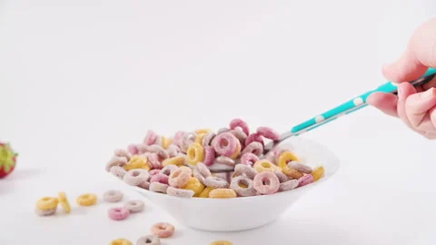 Dry breakfast in a bowl with milk. Multi-colored rings for children's breakfast Stock Footage 204876972