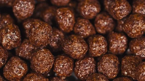 Dry breakfast. Corn balls close up. Chocolate and dairy. The balls are cereal Stock Footage 142437081