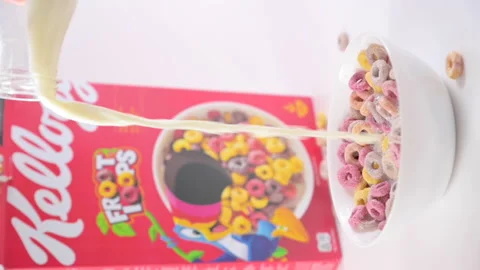 Dry breakfast Kelloggs froot loops in a bowl with milk. Multi-colored rings for Stock Footage 196120592