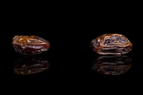 Dry brown date fruit isolated on black glass Stock Photos