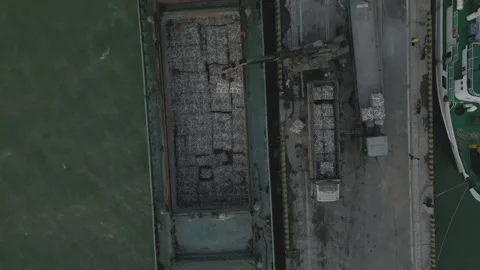 A Dry Cargo Ship With Bales Using A mobile crane Stock Footage 296596369