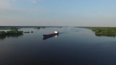 Dry cargo ship floating on the river at dawn. Aerial view. 動画素材 66328751