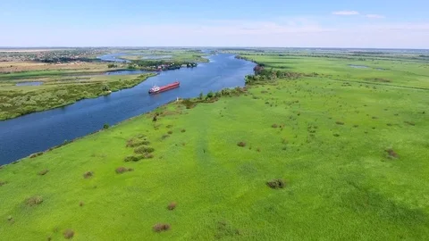 The dry cargo ship sails in the delta of the river. aerial view Stock Footage 83541988