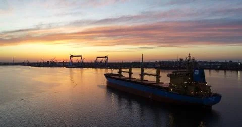 Dry cargo ship at sunset Stock Photos