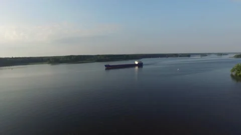 Dry cargo transport vessel sailing on a wide river. Aerial view. Stock Footage 66329051