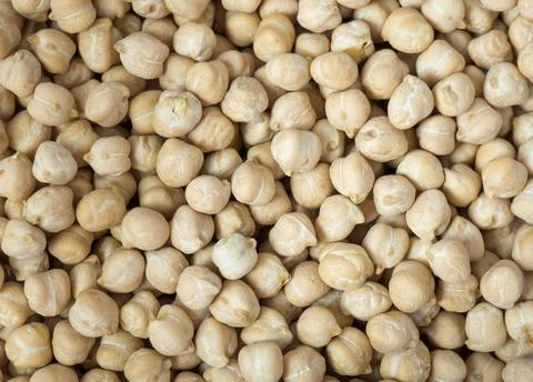 Dry chickpea background, top view. Background of chickpea seeds, close-up. Stock Photos