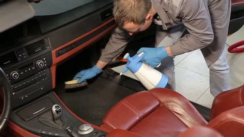 Dry cleaning of a cabriolet.The master brushes the interior of the car.Two shot Stock Footage 76353554