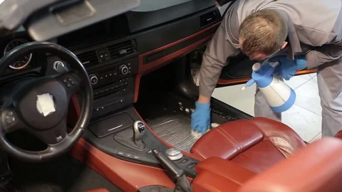 Dry cleaning of a cabriolet.The master brushes the interior of the car.Two shot Stock Footage 76353768