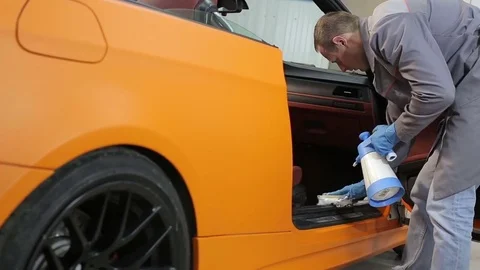 Dry cleaning of a cabriolet.The master brushes the interior of the car.Two shot Video stock 76353950