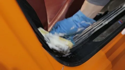 Dry cleaning of a cabriolet.The master brushes the interior of the car. Stock Footage 76354166