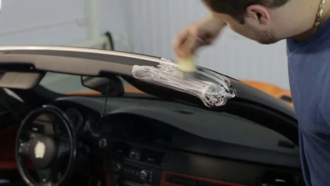 Dry cleaning of a cabriolet .Master cleans the upper body.Two shot Stock Footage 76355156
